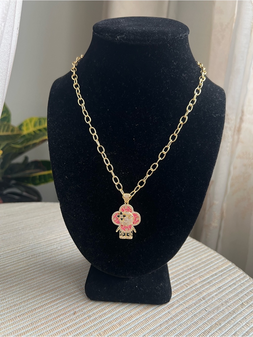 Pink floral face with pavé and engraved accented floral details Gold necklace